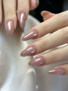 Glossy mauve almond nails with soft glam feminine luxury aesthetic