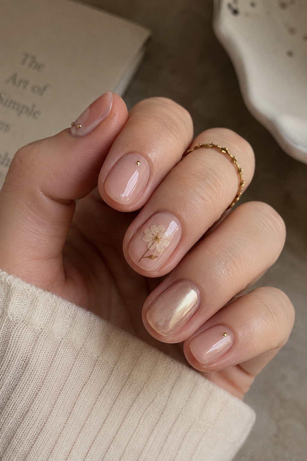 Minimalist and elegant short nails with tiny polka dots and sparkling chrome accents.