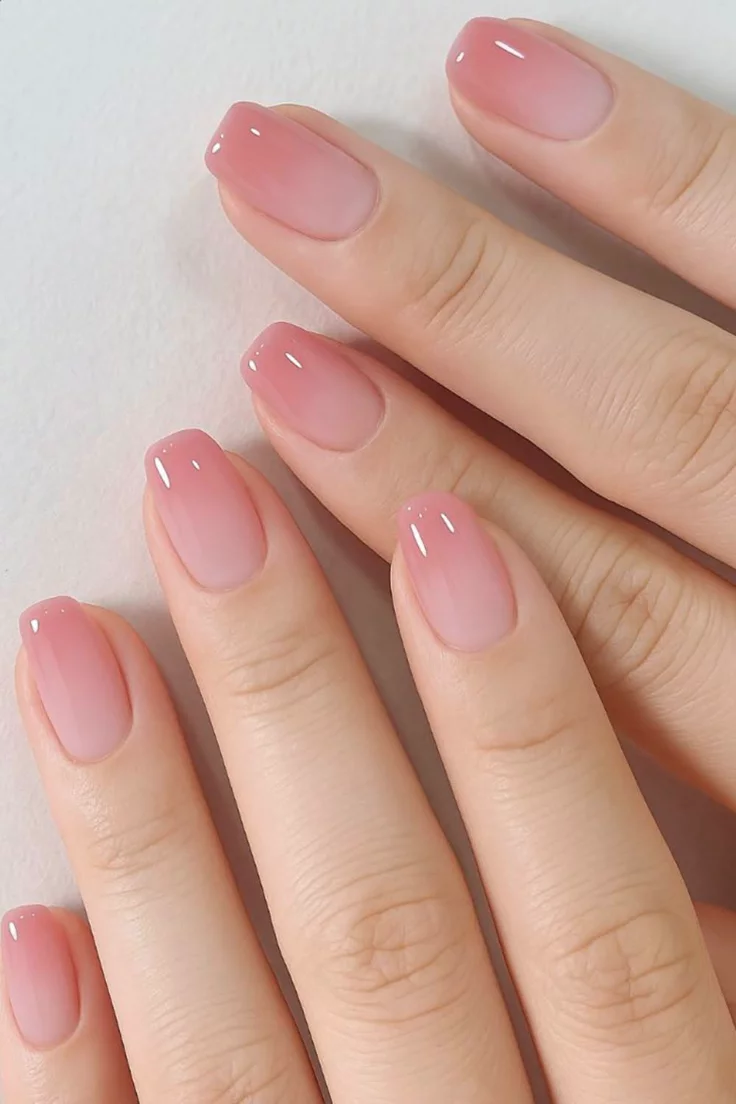 Soft pink ombre nails with a soft gradient transition for a feminine, elegant aesthetic.