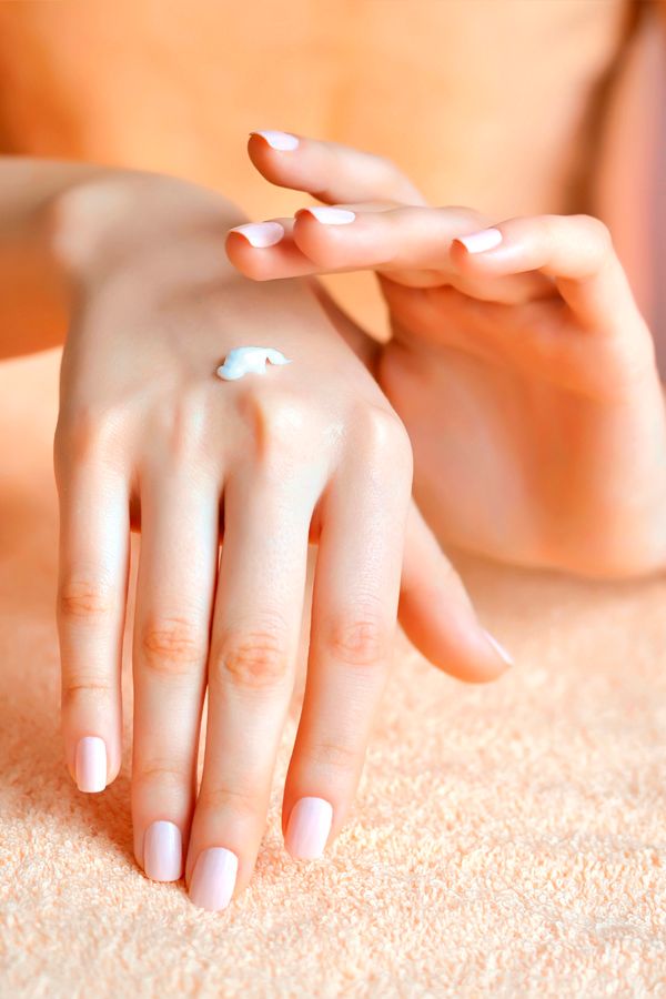 Moisturizing hands and nails with rich hand cream to support soft skin and stronger natural nails.