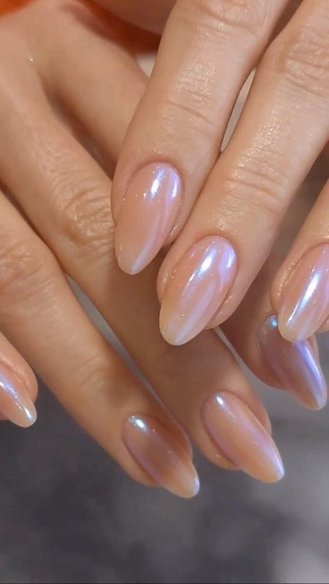 Elegant almond nails with an iridescent sheer pink finish that catches the light beautifully for a soft romantic manicure