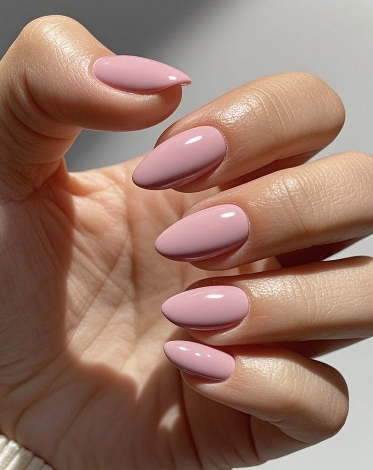 Soft mauve almond nails in a creamy pink-mauve shade with a smooth glossy finish for everyday elegance