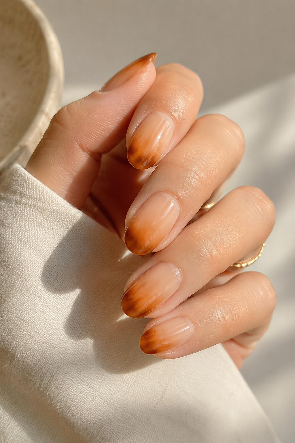 Neutral almond nails with soft tortoiseshell French tips styled for elevated teacher nails.