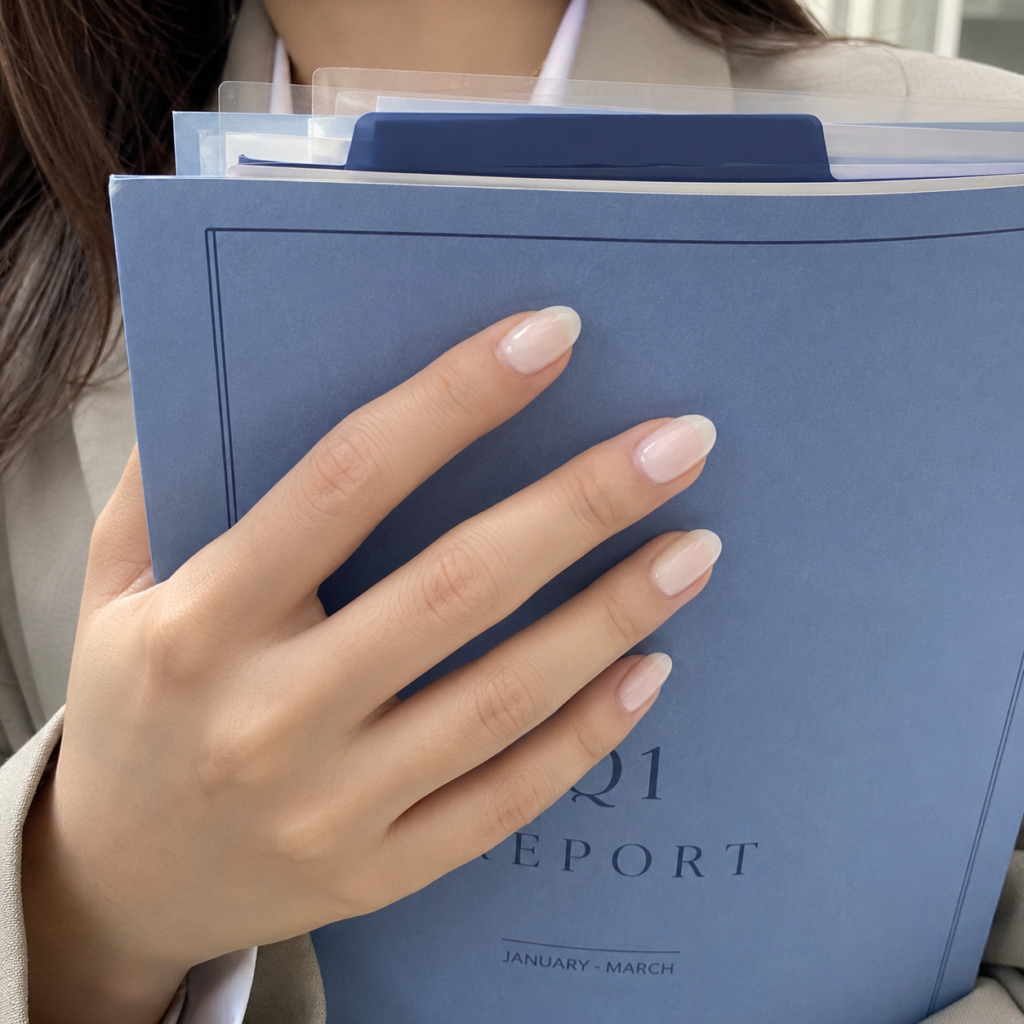 A chic and elegant office-friendly manicure in a soft, milky white finish, capturing the essence of quiet luxury in an office setting.