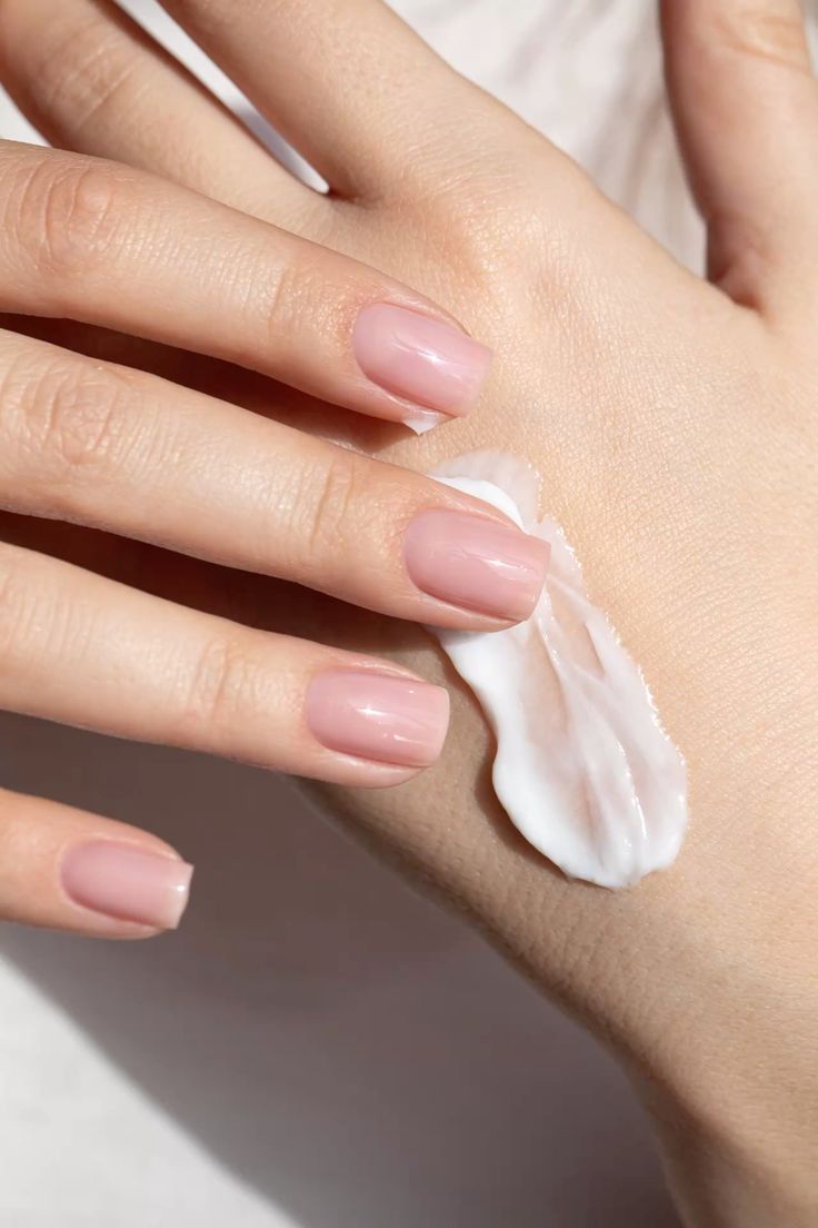 Applying moisturizing hand cream to maintain smooth skin and support Healthy-Looking Minimalist Nails as part of a daily self-care routine.