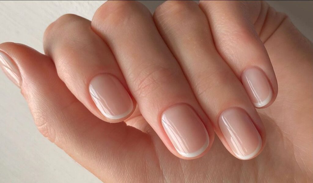 Healthy natural nails after a 30-day nail recovery routine, showing smooth, strong, well-moisturized nail plates