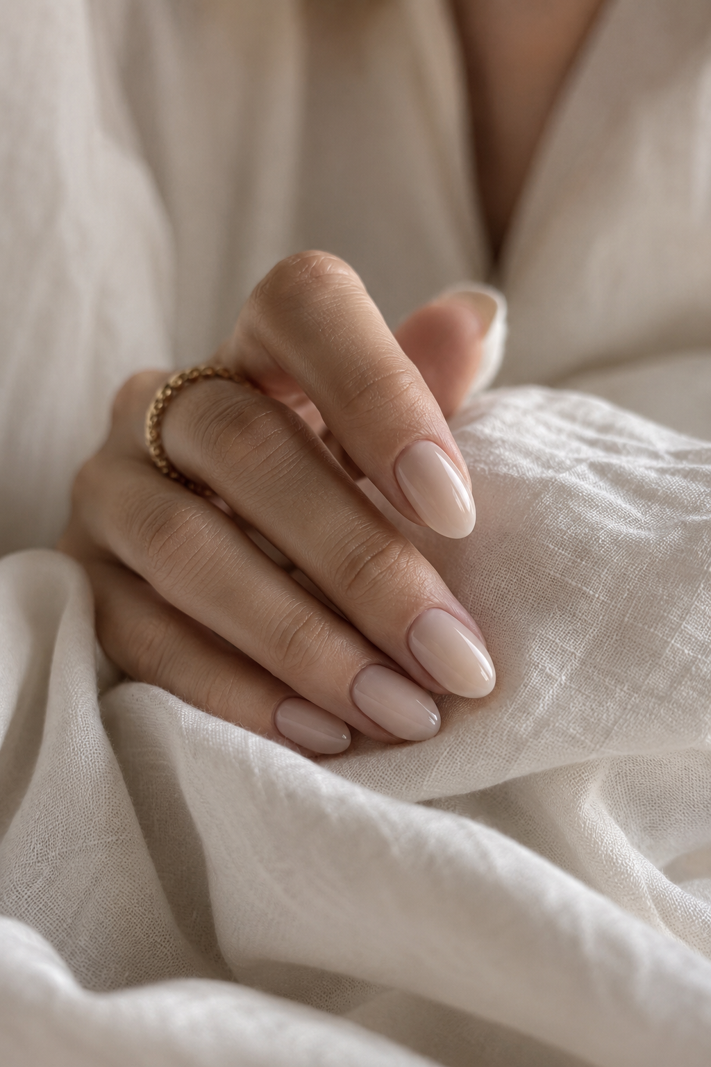 Elegant milky nude press-on nails styled in a soft, quiet luxury manicure look.
