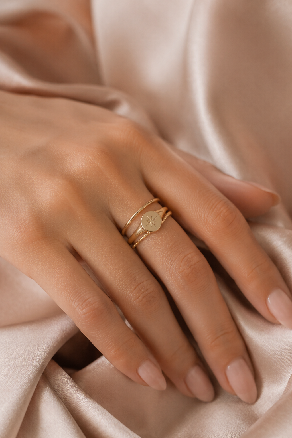 Minimal gold ring stacking on one hand for a quiet luxury look