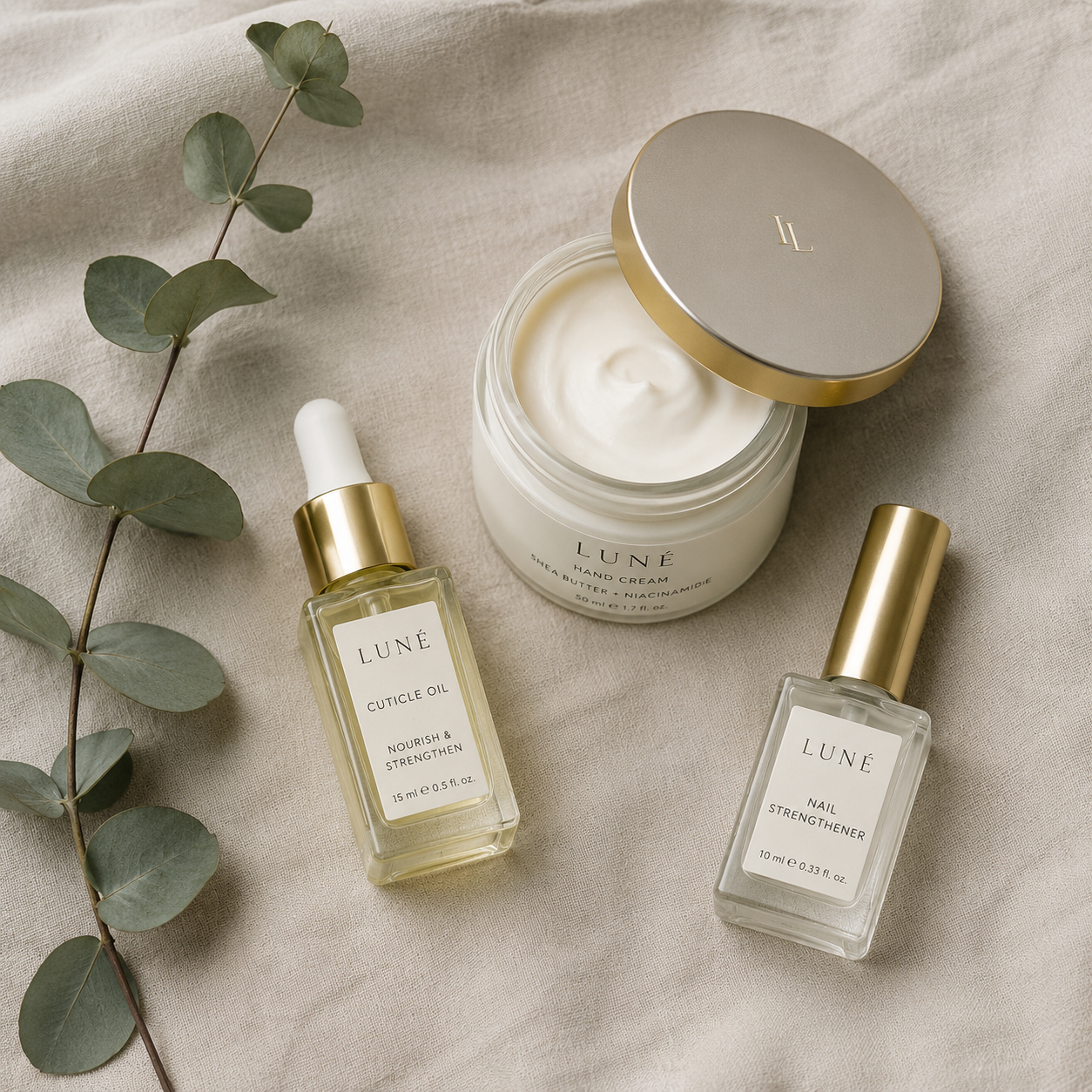 Cuticle oil and hand cream flat-lay for a bridal nail strengthening routine.