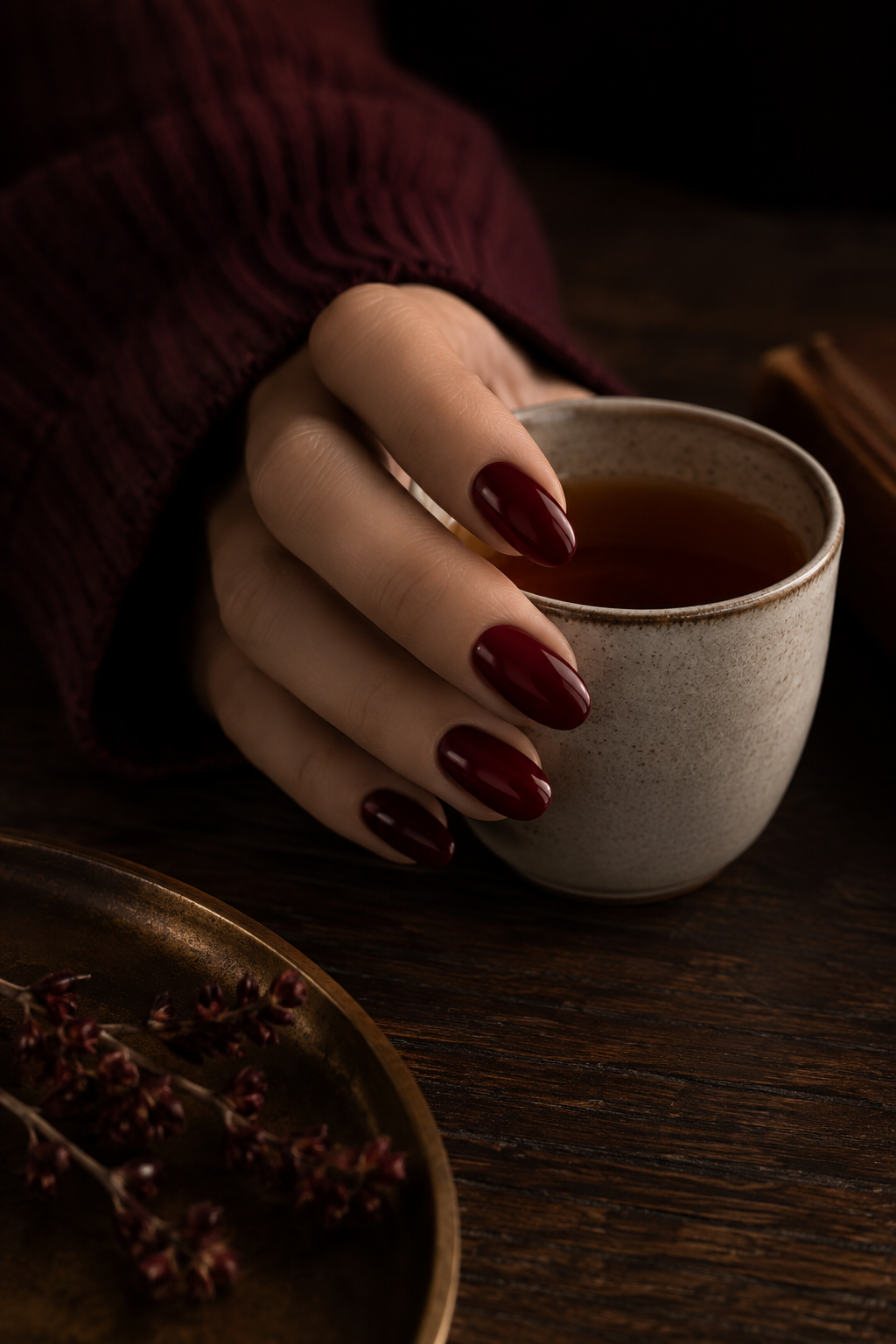 Classic burgundy nail polish styled for an elegant fall manicure