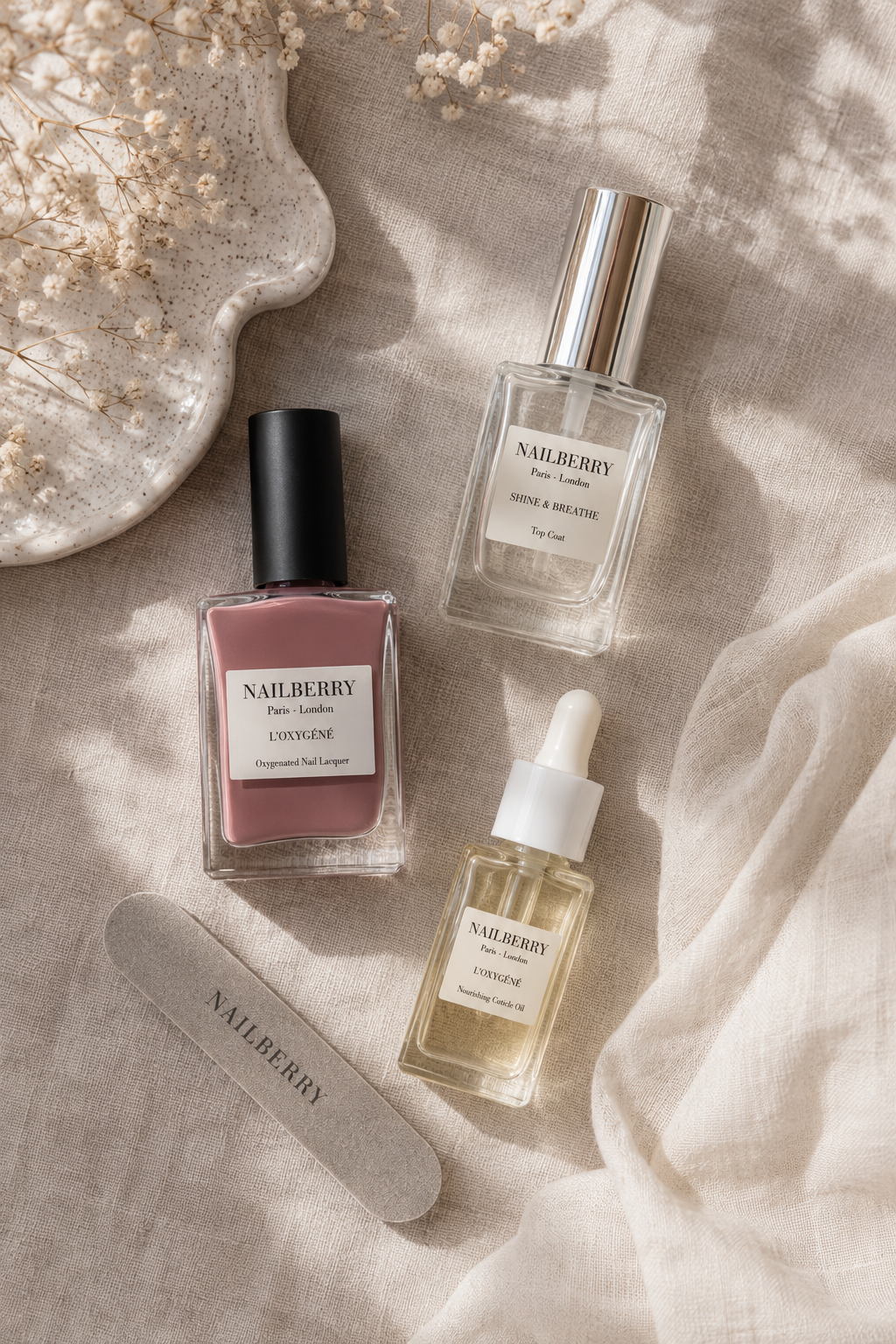 At-home milky mauve nail polish and manicure tools flat lay